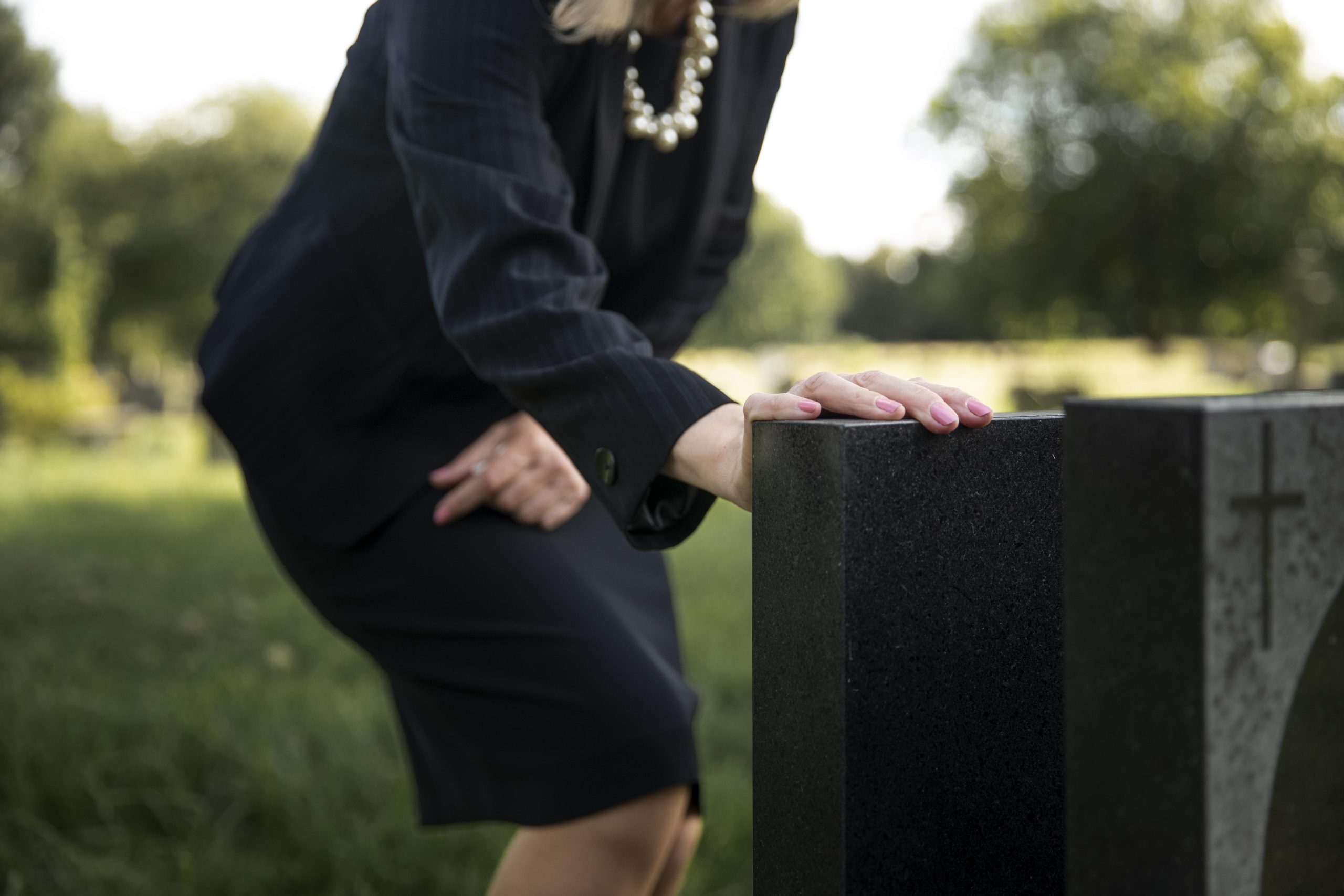 elderly-woman-visiting-grave-loved-one